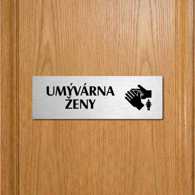 Umývárna ženy, 240x79mm, stříbrná popiska s ozdobou uprostřed